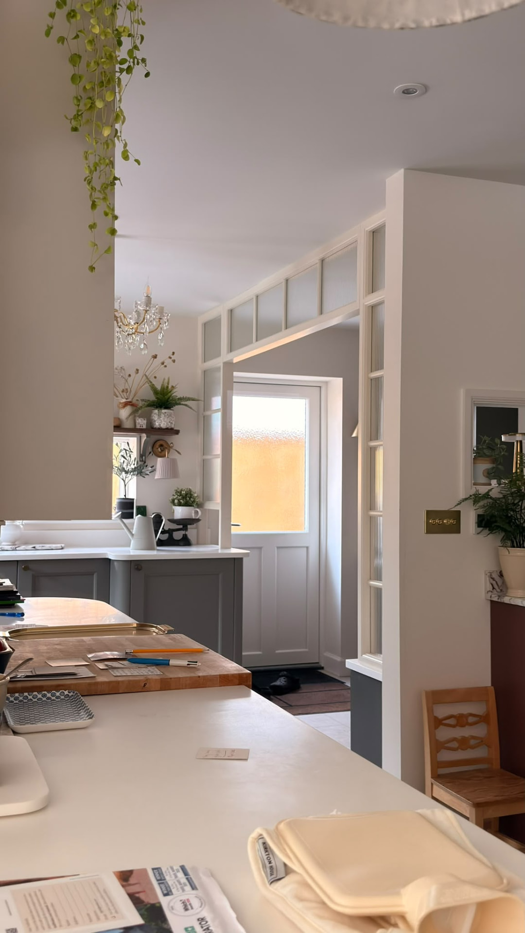 Bespoke glazed internal screen and door surround with reeded glass and painted joinery in a kitchen